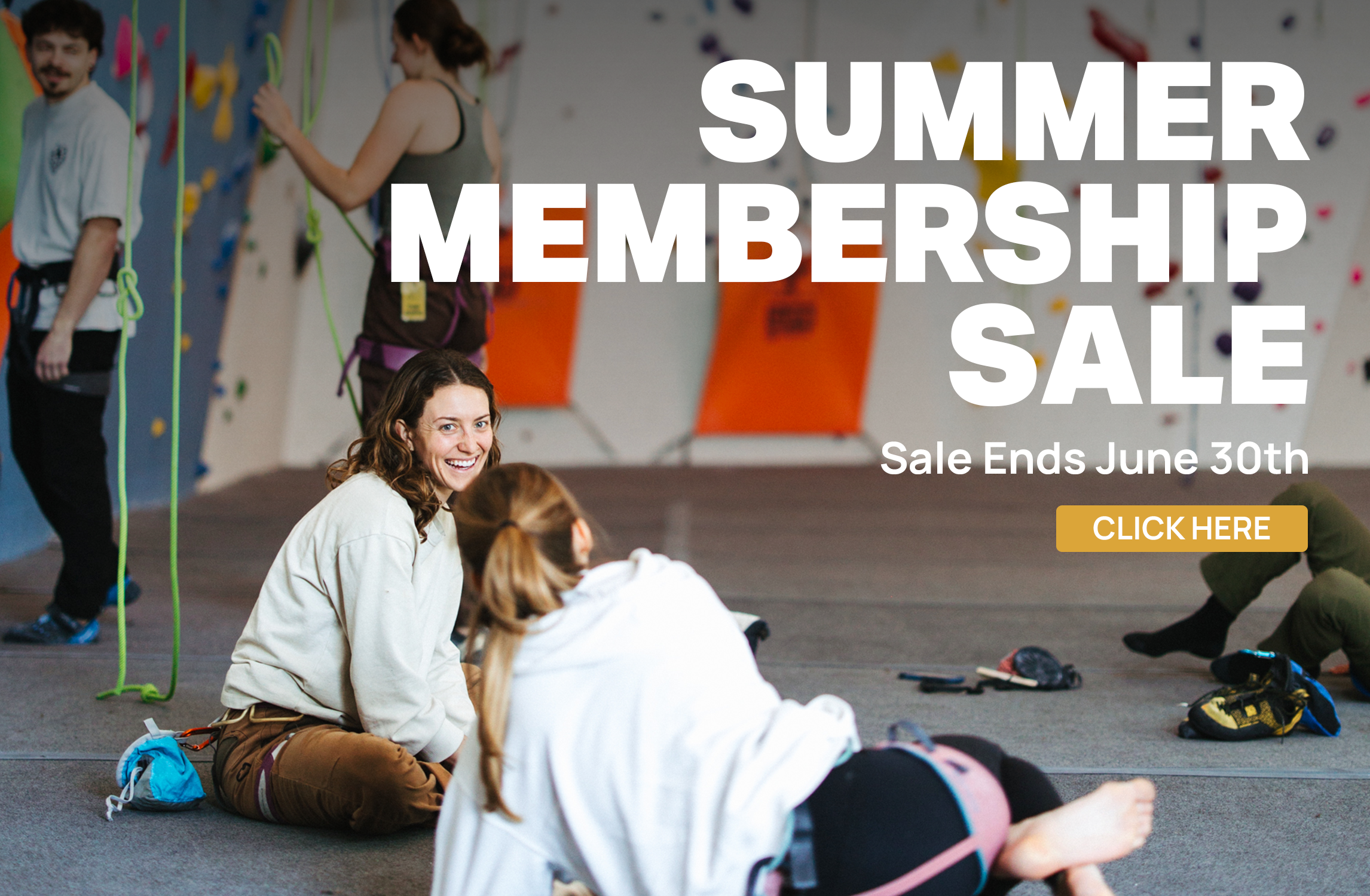 Two people sit on the floor and smile in a rock climbing gym, with harnesses and ropes nearby. Bold text reads, SUMMER MEMBERSHIP SALE. Sale Ends June 30th, and a yellow CLICK HERE button is visible.